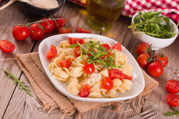 istock Orecchiette pasta with arugula and tomato. 1462118899