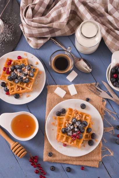 istock Waffles with red currant and blueberries on white dish. 1462119043
