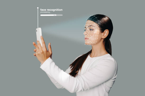 istock Face recognition system on smartphone. Woman scans her face to unlock her device 1462119671