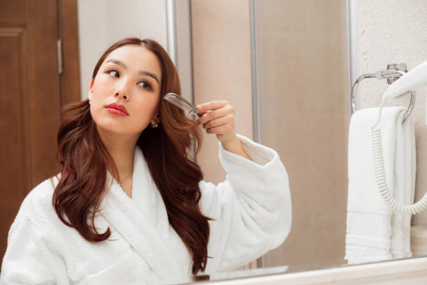 istock Asian woman combing hair 1462121153