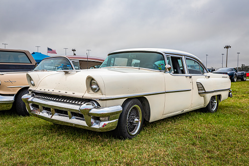 Daytona Beach, FL - November 26, 2022: Low perspective front corner view of a 1955 Mercury Montclair 4 Door Sedan at a local car show.