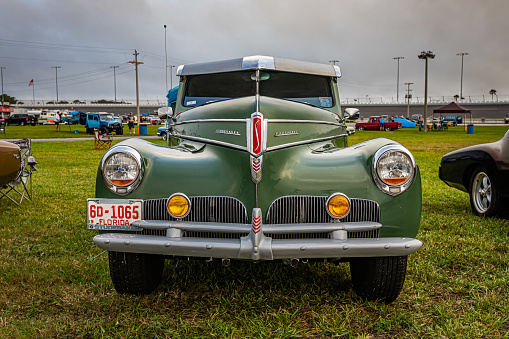 Daytona Beach, FL - November 26, 2022: Low perspective front view of a 1941 Studebaker President 4 Door Land Cruiser at a local car show.
