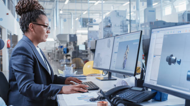 Factory Office Facility: Industrial Engineer Drafting Blueprints of a Heavy Industry Machine Parts on a Computer CAD Software. Modern Technological Industry 4.0 Research and Development Center.