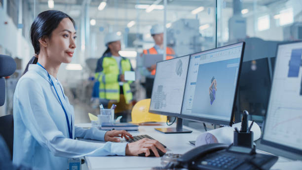 istock Factory Office Facility: Industrial Engineer Drafting Blueprints of a Heavy Industry Machine Parts on a Computer CAD Software. Modern Technological Industry 4.0 Research and Development Center. 1462125777