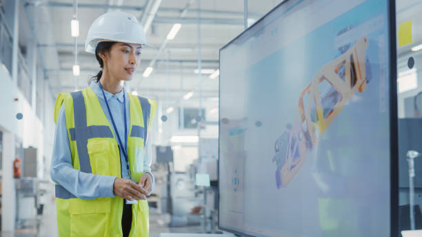 istock Factory Office Meeting: Chief Engineer Explaining New Workflow for Heavy Industry Hydraulic Parts Production to Company Director in a Conference Room with TV. Showing 3D Example on Screen. 1462128579