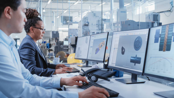 istock Factory Office Room: Industrial Engineers Developing Models of a Heavy Industry Machine Parts on a Computer 3D Software. Modern Technological Industry 4.0 Research and Development Center. 1462131215