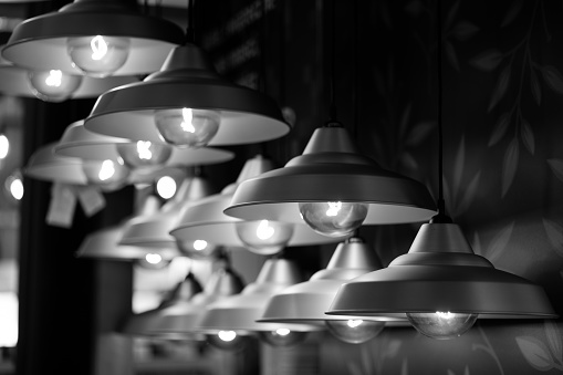 Lamps hangs in the shop. No people. Black and white.