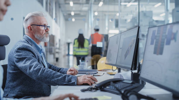 istock Portrait of a Middle Aged Industrial Engineer Developing Models of a Heavy Industry Machine Parts on Computer CAD Software in a Factory. Modern Technological Research and Development Center. 1462134961