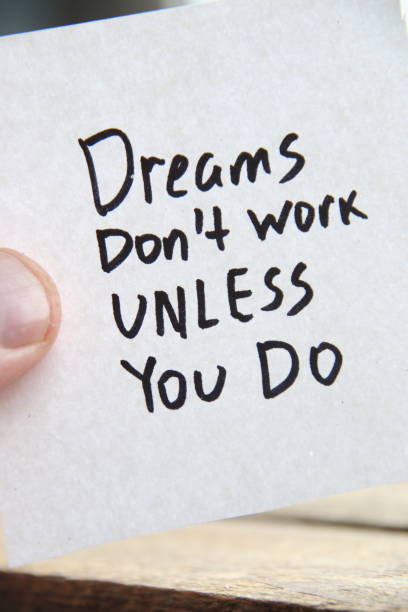 istock Dreams dont work unless you do. Motivational quotes inscription on a tag. 1462136715
