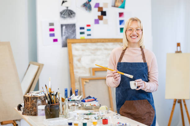 istock Young painter standing in the studio with paintbrush 1462143732