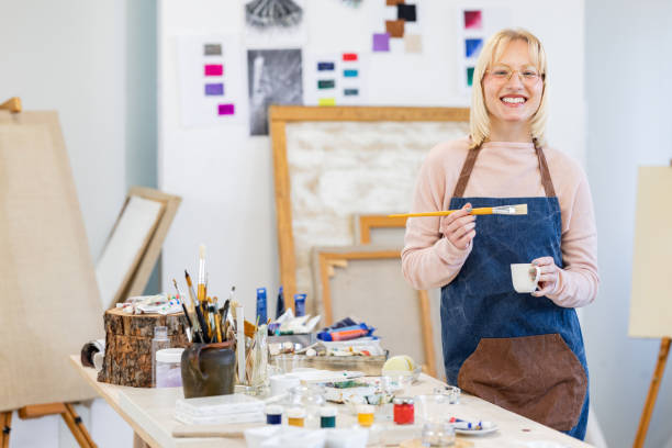 istock Young painter standing in the studio with paintbrush 1462143846