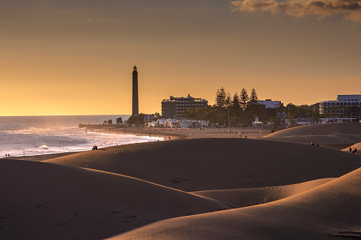 View of Maspalomas ligfhthouse and the dunes of the beach at sunset, Gran Canary, Canary Islands, Spain