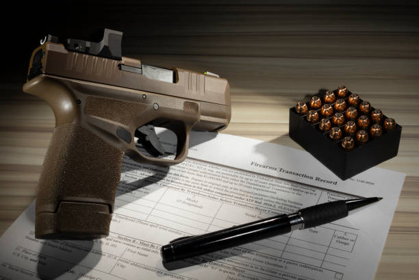 istock 4473 form to purchase a gun with a pistol and ammunition 1462146748