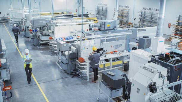 Industrial Factory: Diverse Team of Engineers, Technicians, Professionals and Workers, Working on Production Plant, Optimizing CNC Machinery, Programming Machines, Executing Orders.Top View.