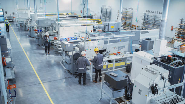 istock Industrial Factory: Diverse Team of Engineers, Technicians, Professionals and Workers, Working on Production Plant, Optimizing CNC Machinery, Programming Machines, Planning Projects. Elevated Shot. 1462146825