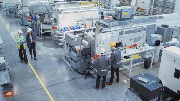 istock Industrial Factory: Team of Engineers, Technicians, Specialists and Workers, Working on Production Plant, Developing CNC Parts, Programming Machines, Executing Orders. Elevated angle 1462146877