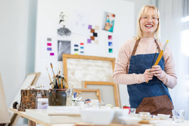 istock Young painter standing in the studio with paintbrush 1462148710