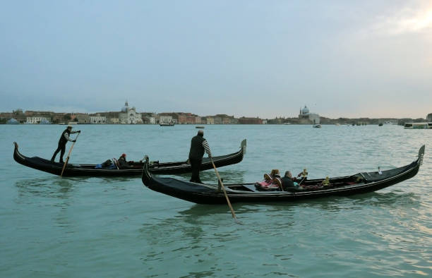Venice, Italy - 03 02 2018. Tourists on gondola during sunset. Lifestyle in Venice.