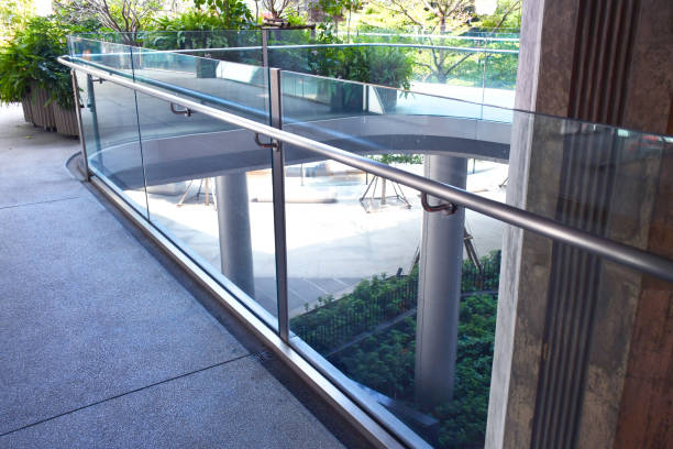 istock Curve tempered laminated glass railing balustrade panels frame less ,safety glass for modern architectural buildings. Concept for Aluminum balcony or terrace design with glazing profile. Company and industry portfolio image. 1462151156