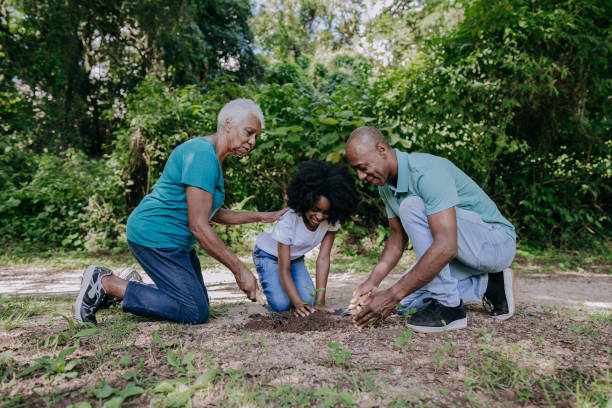 istock Three generation family planting a tree 1462151187