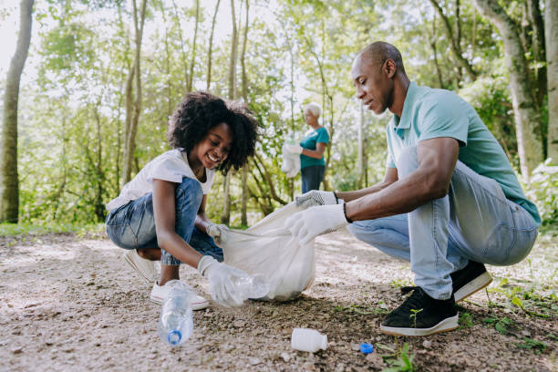 istock Father and daughter picking up trash in nature 1462151733