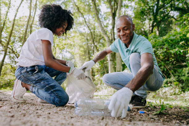 istock Father and daughter picking up trash in nature 1462151734