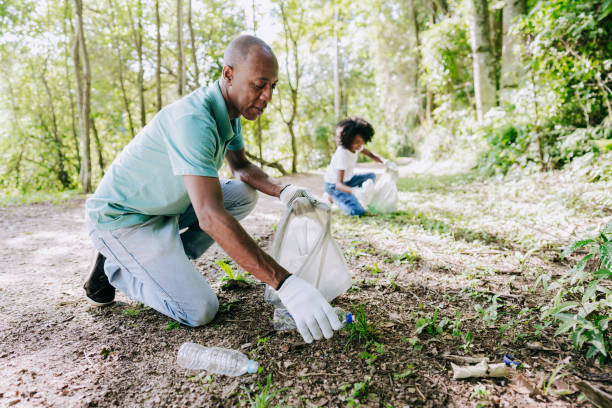 istock Mature man picking up trash in nature 1462151741
