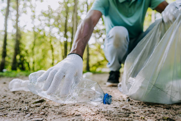 istock Man concerned about nature picking up garbage 1462151846