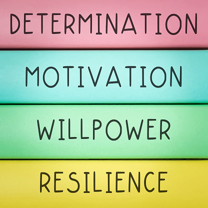 Motivational and inspirational quotes - Determination, Motivation, Willpower, Resilience with wooden background.