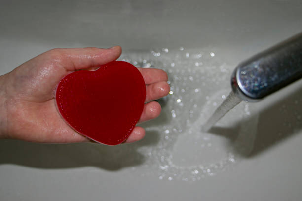 istock The child washes his hands with heart-shaped soap. 1462154494