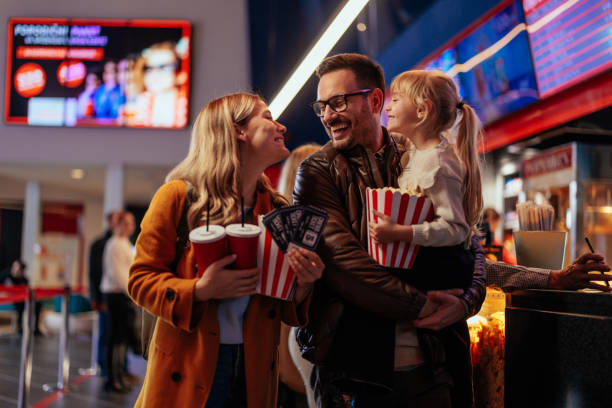Family bonding at movie theater. stock photo