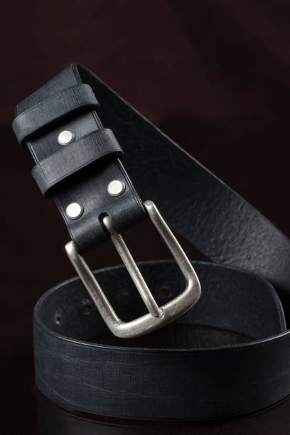 istock Black leather belt on a dark background. Leather products. 1462171404