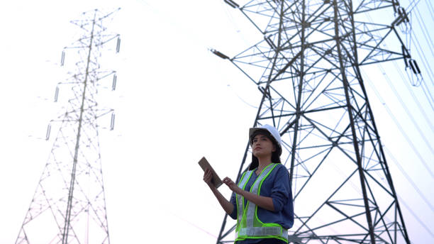 istock specialist electrical engineer working near to High voltage tower. 1462175251