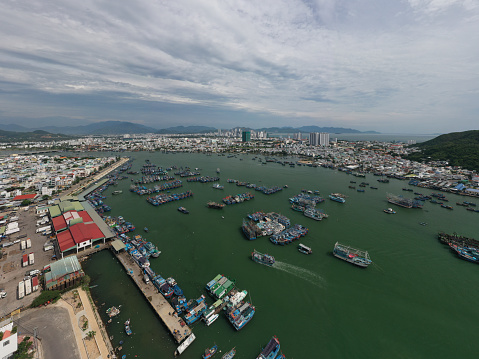 Drone view of fishing boats are nailing by the fish farm on the Cua Be riverfront, Nha Trang city, Khanh hoa province, central Vietnam
