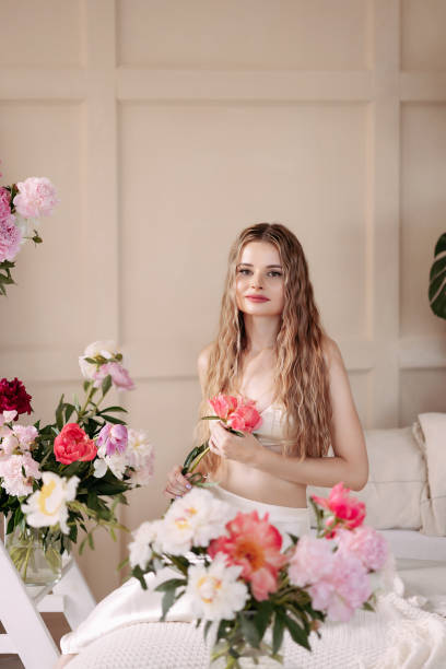 istock A beautiful young woman with long hair sits in a studio 1462178836