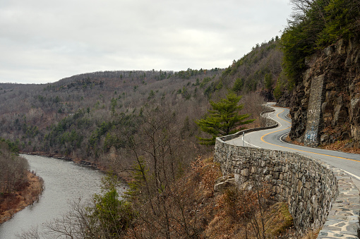 The Delaware River runs along the winding road at Hawks Nest, New York State.