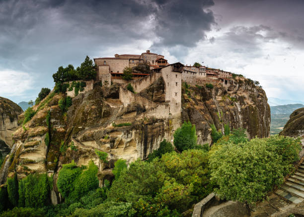 Amazing panoramic landscape of monastery on a rock. The Monastery of Great Meteoron is an Eastern Orthodox monastery. Meteora monastery complex. Thessaly. Greece. UNESCO World Heritage List. stock photo