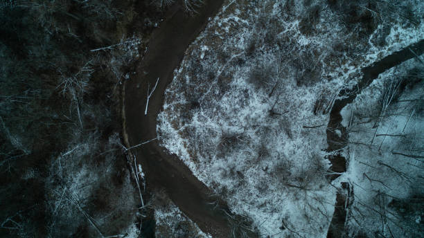 istock Looking down at a snowy Creek in a forest Valley from a birds eye view during winter 1462184695