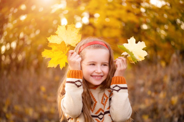 istock Child playing with autumn leaves 1462184961