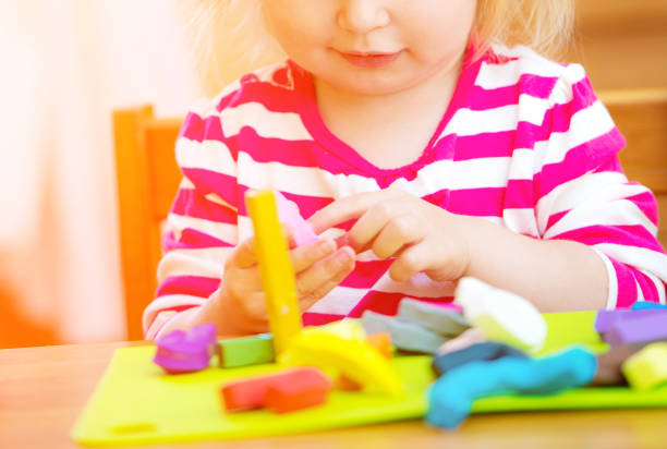 istock Little girl playing with plasticine 1462185315
