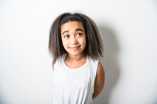 An Adorable 9 years child girl on studio white background