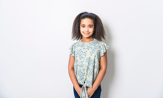 An Adorable 9 years child girl on studio white background