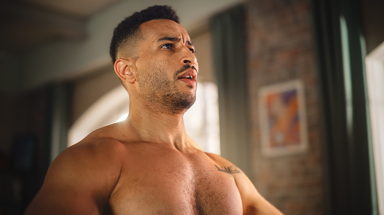 Home Gym Training: Handsome Muscular Black Man Using Kettlebell, Does Endurance Exercise. Strong Mixed Race Sportsman Workout. Energetic Action. Close-up Portrait Shot