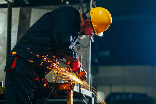 istock Senior with protective goggles grinding in  factory. 1462188084