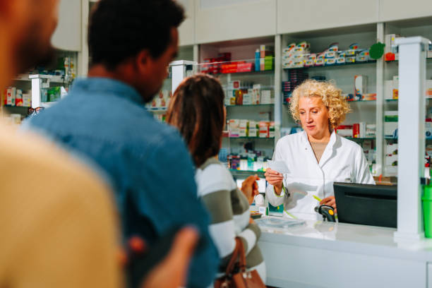 istock Pharmacist working in busy pharmacy. 1462188126