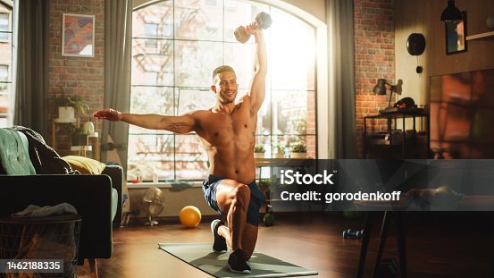 istock Portrait of a Strong Athletic Black Man Doing Shirtless Workout at Home, Training with Dumbbells. Fit Muscular Sportsman Staying Healthy, Training at Home. Sweat, Determination. Low Angle 1462188335