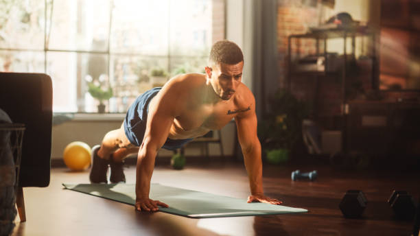 istock Strong Athletic Black Man Does Shirtless Workout at Home Gym, Doing Push Ups. Lean Fit Muscular Mixed Race Sportsman Staying Healthy, Training at Home. Sweat and Determination lead to Success 1462189075