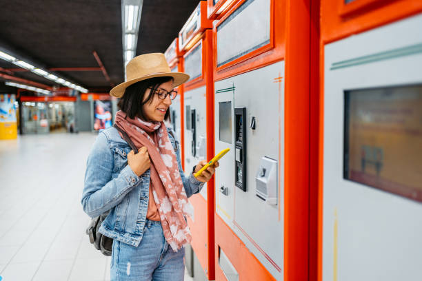 istock Young Woman Buying A Ticket Using Phone For A Subway Train In Milan 1462193775