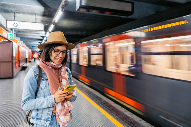 istock Young Woman Using Phone While Waiting For The Subway Train In A Subway Station 1462193997