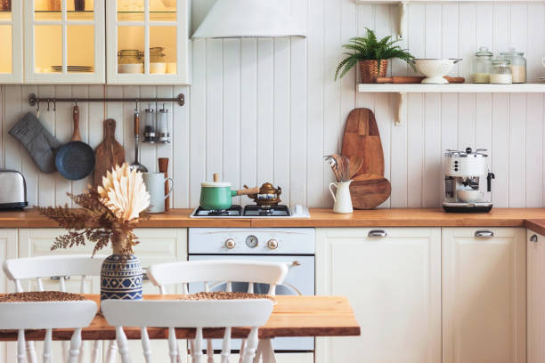 istock Kitchen wooden table and kitchen background. Interior style is cosy and scandinavian. High quality interior scandi photo. 1462194381
